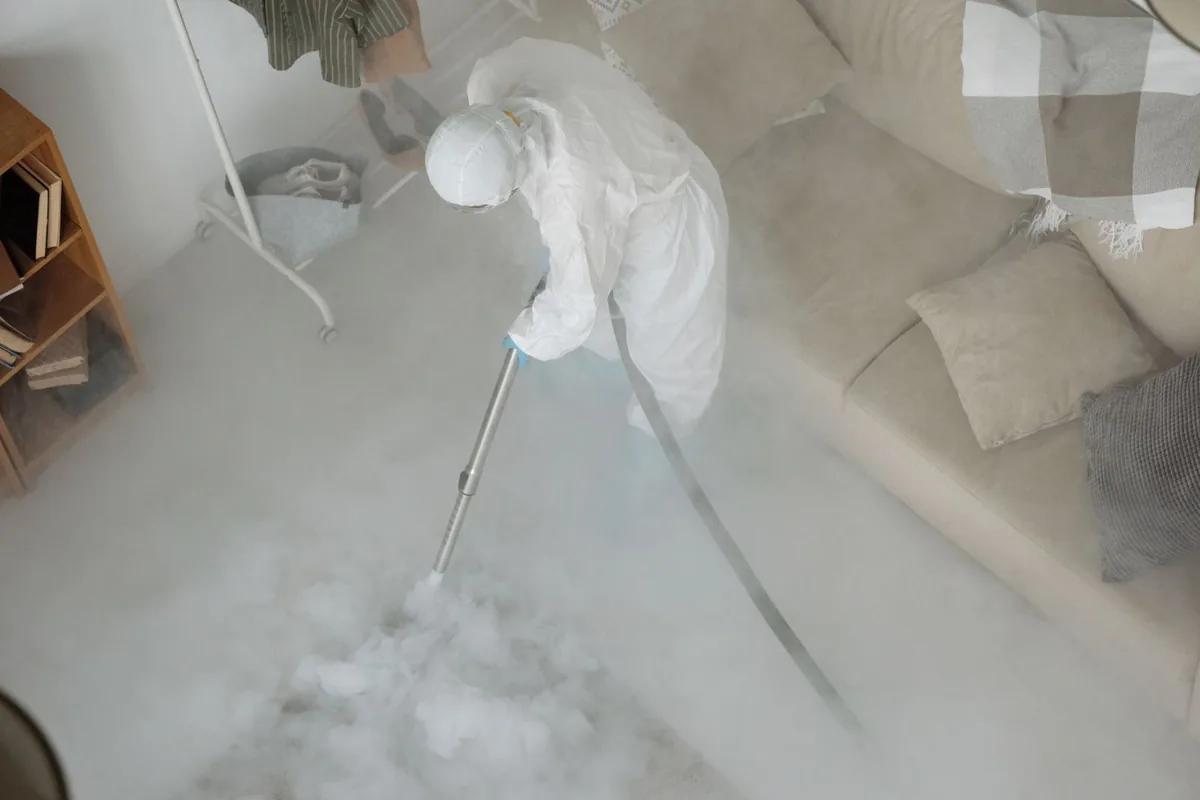 Biohazard cleanup technician in protective equipment, Onset, MA